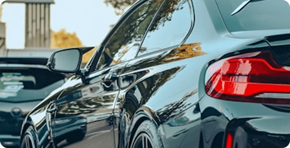 Black BMW sedan side view with illuminated taillight